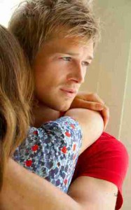 fashion shot of a young man comforting his girlfri